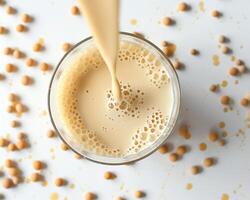 chickpea milk in a glass with soybeans around it photo