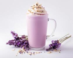 a glass of milk with whipped cream and lavender flowers photo