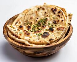 a bowl of flatbread with herbs on top photo