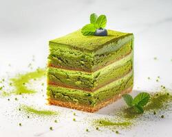 a piece of green cake with mint leaves on top photo