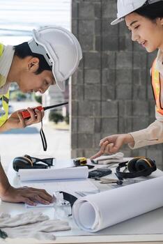 Engineer Teamwork Meeting, Drawing working on blueprint meeting for project working with partner on model building and engineering tools in working site, Construction and structure concept. photo