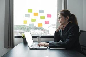 Accounting planning budget concept Business woman offices working for arranging documents unfinished stack of document papers with pen photo