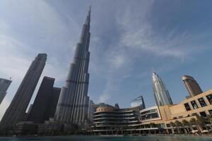 uae, dubai , 1th December 2022 a picture of the burj khalifa with towers and buildings in the night with small lake photo