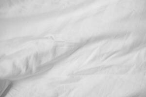 Abstract White Bedding Sheets or White wrinkled fabric background texture and Texture with copy-space Creased or wrinkled white fabric,Soft focus photo