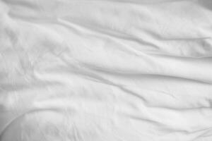 Abstract White Bedding Sheets or White wrinkled fabric background texture and Texture with copy-space Creased or wrinkled white fabric Soft focus photo