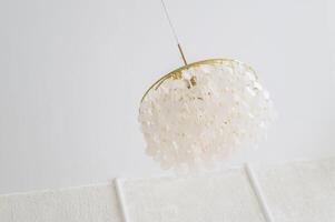 Elevate your home or office with a bright and shiny ceiling lamp, a luxurious addition to any room. photo