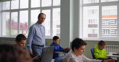 Exam Of Math Or Informatics In Computer-Based Classroom In School, Teacher Walking Between Rows video