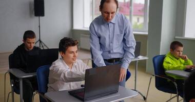 Teen Boy Student Communicating With Teacher Of Programming Classes, Pupils Working With Laptops video