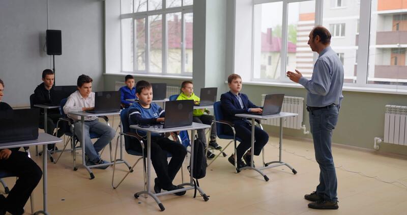 Teacher And Little School Boys In Computer-Based Class, Programming And ...