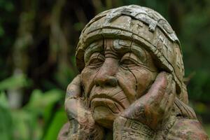 Contemplative stone statue in a garden photo
