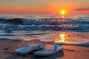 Serene beach sunset with flip flops photo