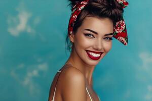 Beautiful brunette model with red lipstick smiling on blue background photo