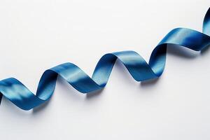 Blue curled ribbon creating a wave shape on white background photo