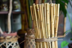 Bundle of bamboo stalks standing in a workshop photo