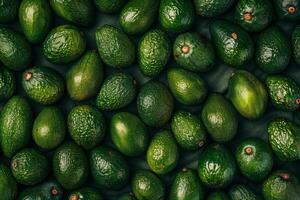 Top view of ripe avocados in a neat pattern, showing texture and green hues photo