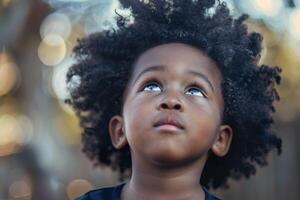 Young child is looking up with a thoughtful expression photo