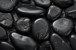 Polished black tourmaline minerals are arranged showing texture and natural patterns photo