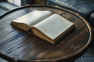 Open book lying on round wooden table is showing literature wisdom knowledge and information photo