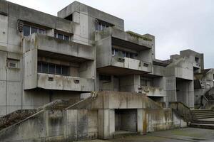 Brutalist style concrete building with multiple levels and staircases photo
