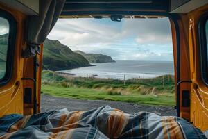 Waking up in a camper van with a view of the ocean and green hills photo