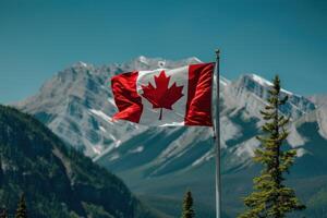 Canadian flag waving in the wind with rocky mountains background photo