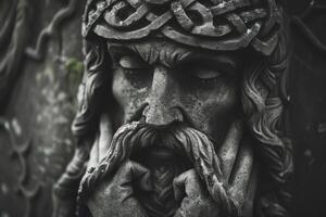 Ancient stone statue of jesus christ wearing crown of thorns photo