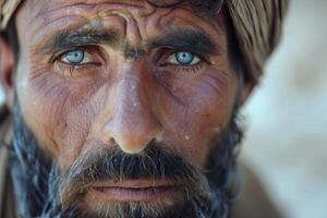 Intense gaze of a bearded man with piercing blue eyes photo