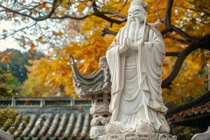 Ancient sage statue in autumn park photo