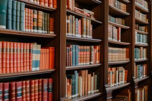 Classic library bookshelves with antique books photo