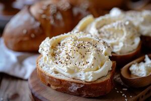 Cream cheese spread on artisan bread with seeds photo