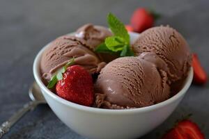 Chocolate ice cream with fresh strawberry garnish photo