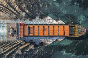 Aerial view of cargo ship navigating through sea channels photo