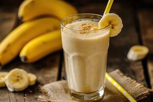 Fresh banana smoothie on wooden table photo