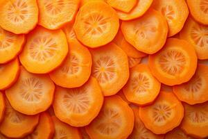 Top view of vibrant orange carrot slices closely packed in a fullframe pattern photo