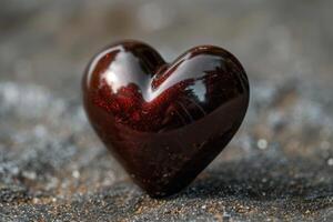 Closeup of a shiny red heart on textured surface photo