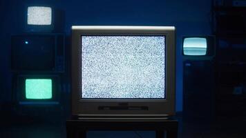 Pan up of cords and lighting on floor to static tv's flashing video