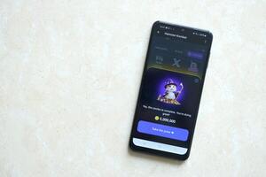 KYIV, UKRAINE - APRIL 20, 2024 Hamster Kombat telegram bot on smartphone screen. Hamster Kombat is a viral Telegram crypto game for earn HMSTR tokens by managing virtual crypto exchange photo