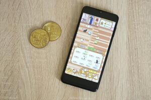 KYIV, UKRAINE - APRIL 20, 2024 Catizen telegram bot on smartphone screen. Catizen is a viral Telegram based crypto game for earn tokens by managing virtual crypto exchange photo