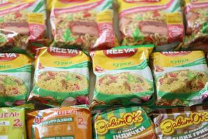 KYIV, UKRAINE - APRIL 20, 2024 Many packs of instant noodles for fast cooking by various brands and manufacturers photo
