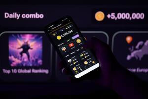 KYIV, UKRAINE - APRIL 20, 2024 Hamster Kombat telegram bot on smartphone screen. Hamster Kombat is a viral Telegram-based crypto game for earn HMSTR tokens by managing virtual crypto exchange photo