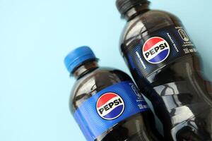 KYIV, UKRAINE - APRIL 20, 2024 Pepsi plastic bottle drink and cap. Pepsi is carbonated soft drink produced by PepsiCo photo