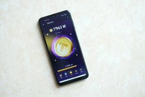 KYIV, UKRAINE - APRIL 20, 2024 Tap Swap telegram bot on smartphone screen. Tap Swap is a viral Telegram based crypto game for earn tokens by managing virtual crypto exchange photo