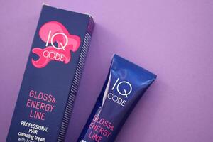 KYIV, UKRAINE - OCTOBER 31, 2023 Tube of IQ Code Gloss and Energy Line colorizer cream for hair photo