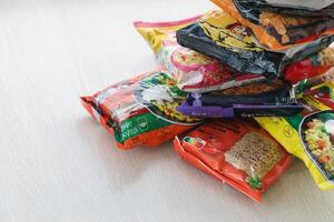 KYIV, UKRAINE - OCTOBER 31, 2023 Many packs of instant noodles for fast cooking by various brands and manufacturers photo