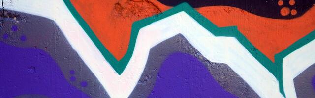 Colorful background of graffiti painting artwork with bright aerosol outlines on wall. Old school street art piece made with aerosol spray paint cans. Contemporary youth culture photo