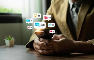 Young Man Using Smartphone with Multiple Social Media Notifications Displayed on Screen, Engaging in Digital Communication and Social Networking, Busy Lifestyle with Technology Interaction photo