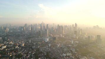 Aerial view of Jakarta city skyline with air pollution at dawn, Indonesia. video