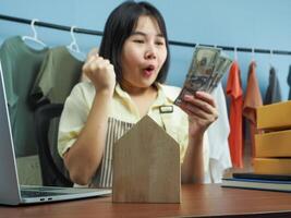 a woman holding money photo