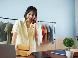 a woman is talking on the phone while sitting at a desk photo