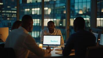 Team discussing charts in a night meeting. Business professionals working late in a corporate office with laptop displaying data. photo